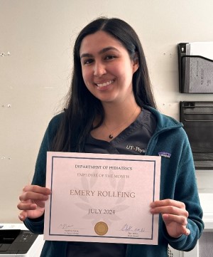 Emery holding her certificate.