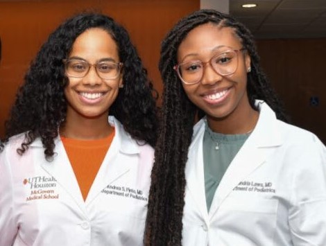 Drs. Pinto and Laws pose together in white coats.