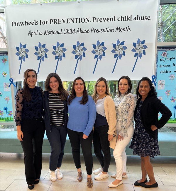 CARE Team in front of banner