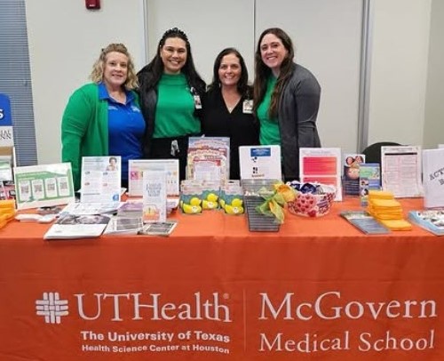 UTHealth Houston employees at table at community health fair