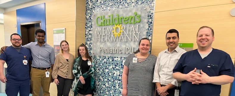 Fellows in front of PICU sign