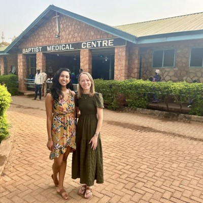 Two doctors pose in front of Baptist Medical Centre building