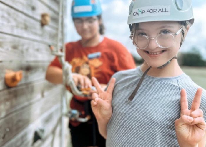 Camper in climbing gear smiling