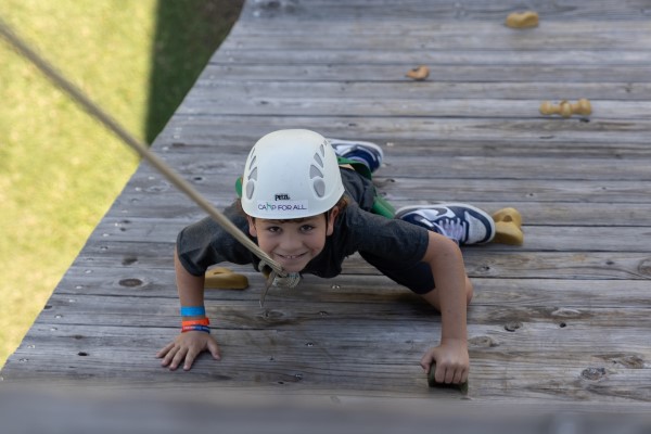 Camper climbing up a rock wall