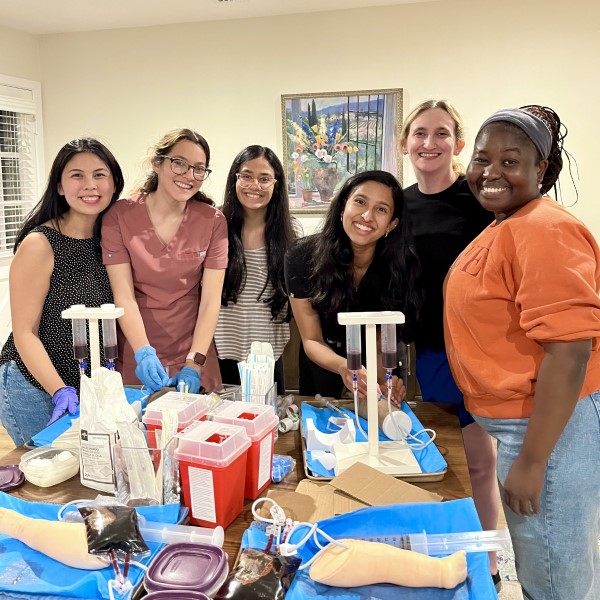 Smiling residents gathered around a simulation table