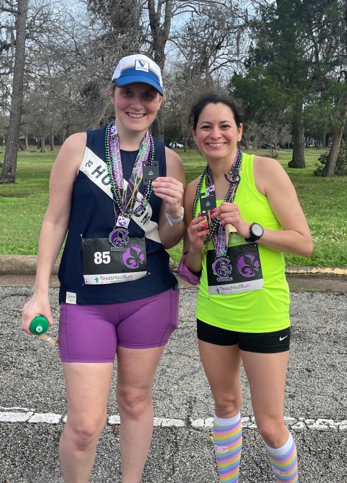 Two runners hold awards