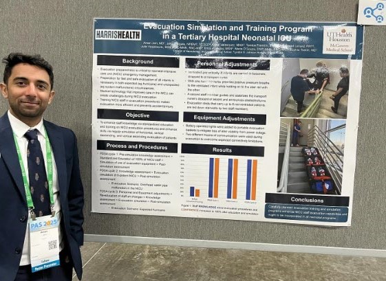 Doctor standing in front of research poster