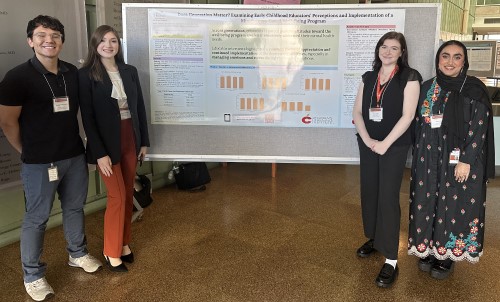 People standing in front of research poster
