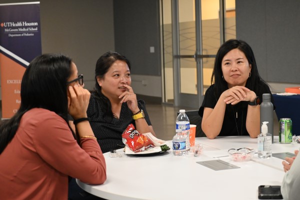 Three people at a round table