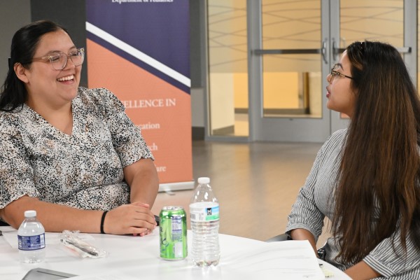 Two women at a table, chatting