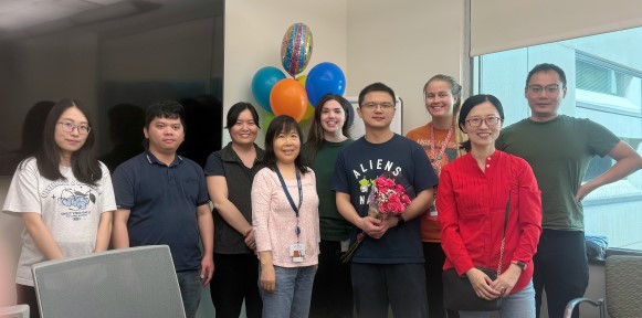 Group of people with balloons in the background