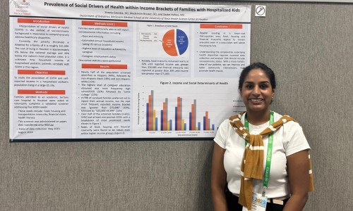 Doctor standing in front of research poster