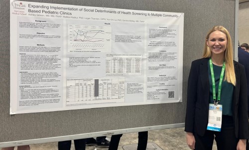 Doctor in front of research poster