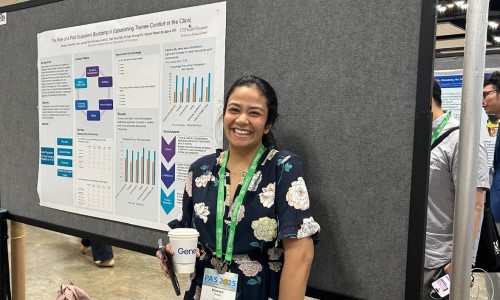 Doctor standing in front of research poster