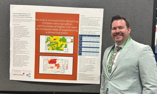 Doctor in front of research poster