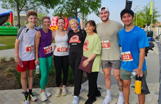 Group of people smiling after a fun run event