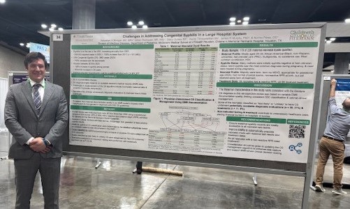 Doctor standing in front of research poster