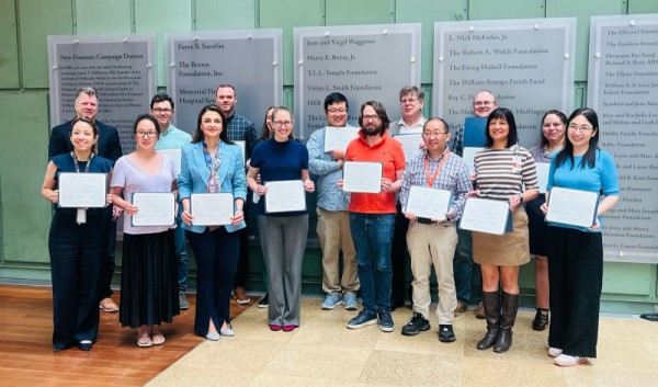 Group of people holding certificates