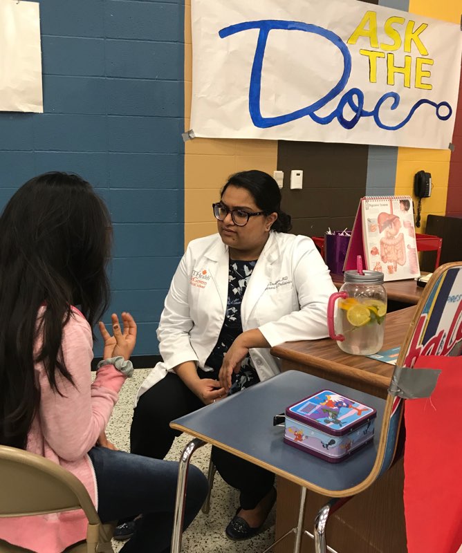 Young patient talks with doctor at table