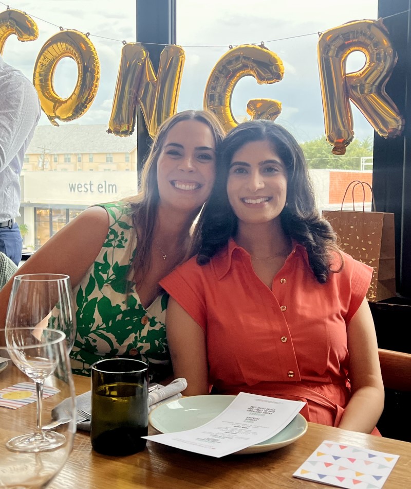 Two women smiling at restaurant table