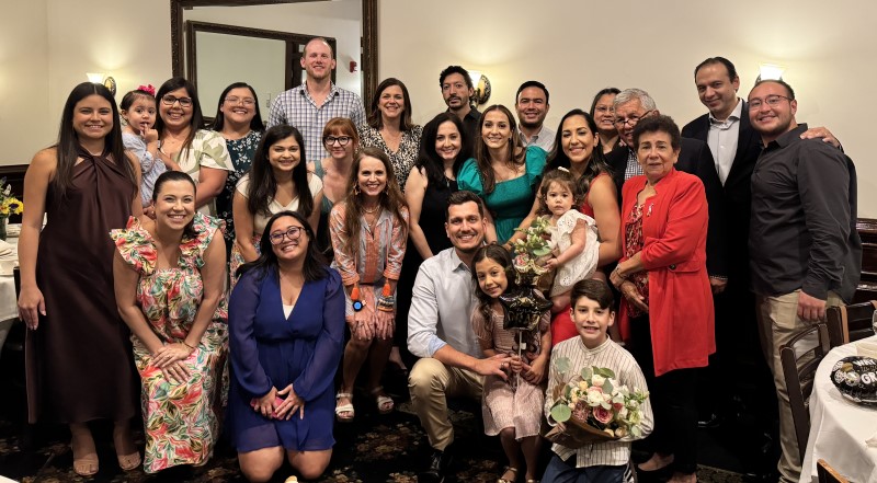 Group of people posing in restaurant banquet room