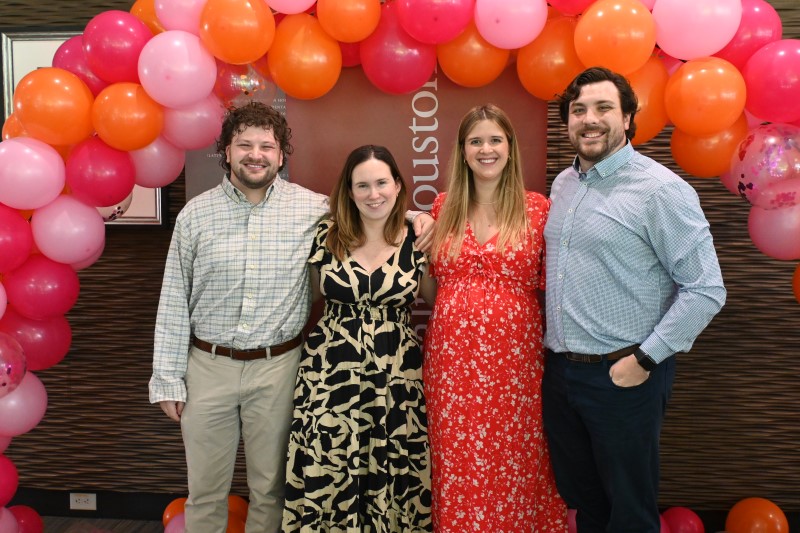 Four doctors in front of balloon arch