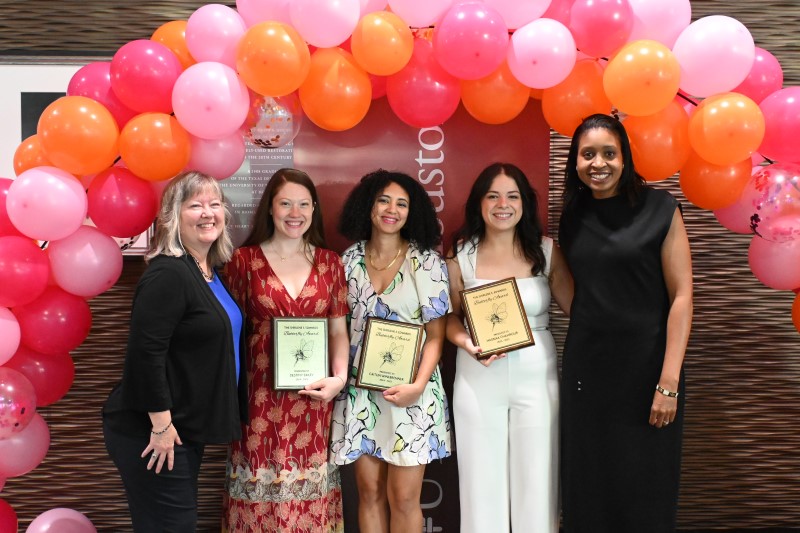 Five women in front of balloon arch