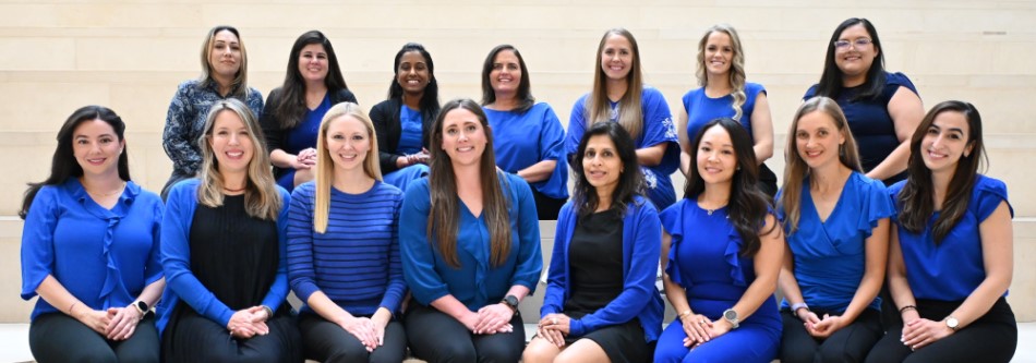 Group of 15 women sitting in two rows on steps