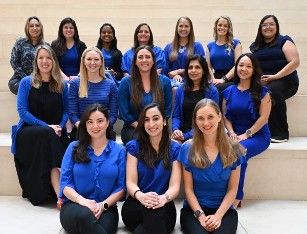 Three rows of women wearing blue and black