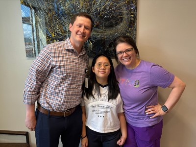 Doctor, patient, and occupational therapist smiling together