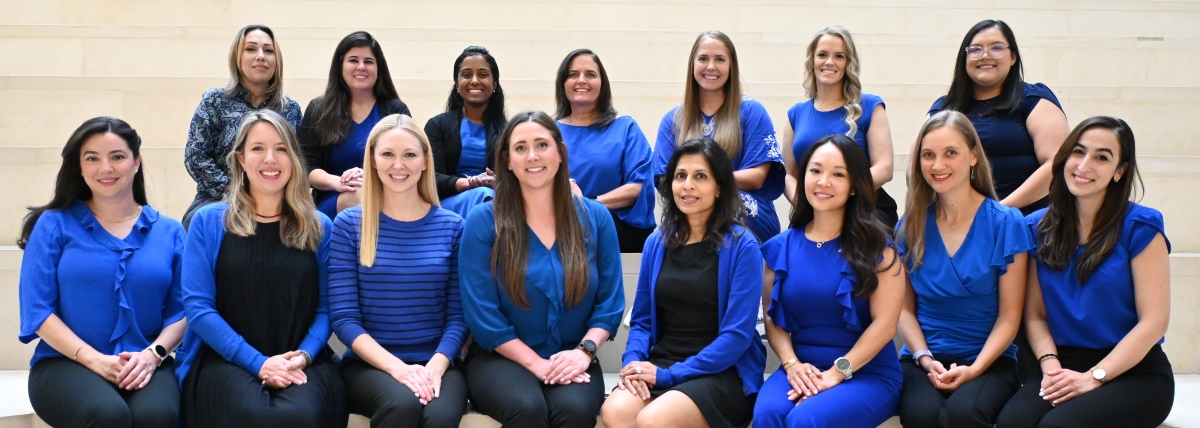 Group of 15 women sitting in two rows on steps