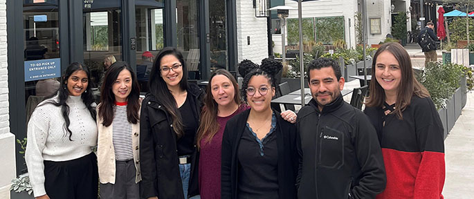 Group of 7 people in front of restaurant