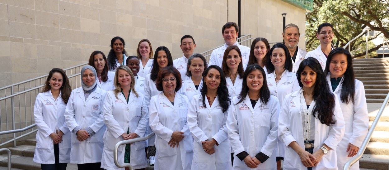 Group of doctors in white coats standing on steps
