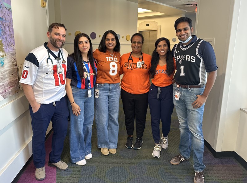 Six doctors wearing team jerseys