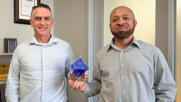 Two holding award plaque