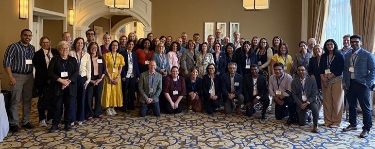 Huge group photo of people in a hotel ballroom