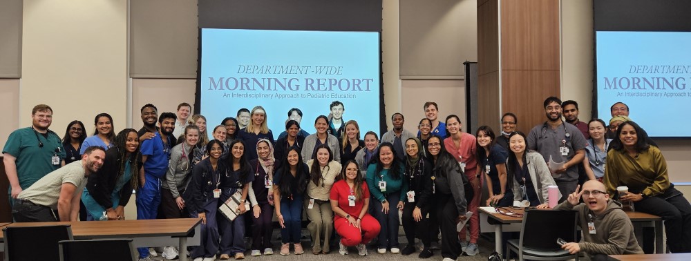 Large group of doctors smiling in conference room 