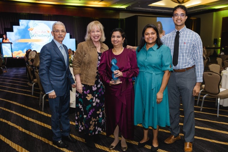 Five people posing together at luncheon