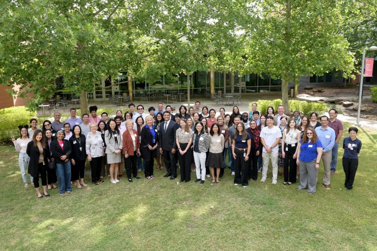Large group of people standing on lawn