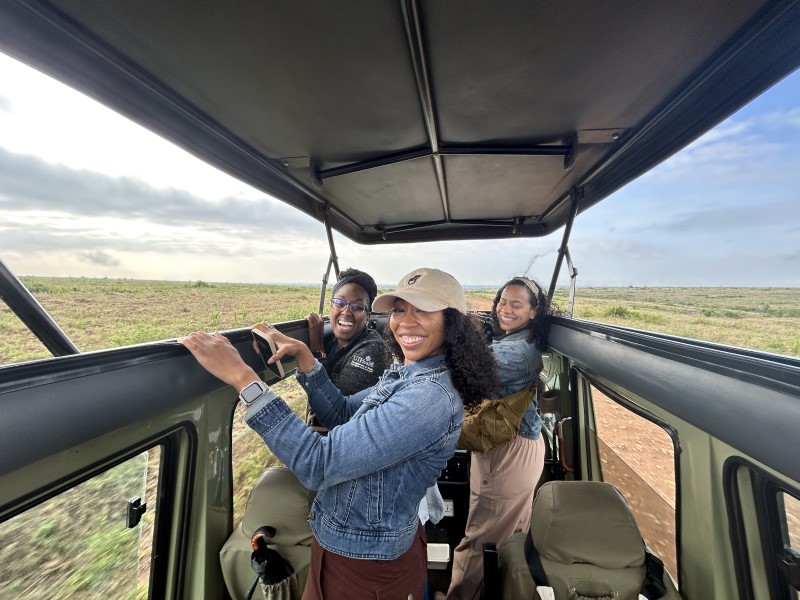 Three women in the back of a safari truck