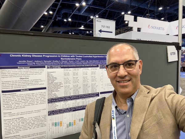 Man taking selfie in front of research poster