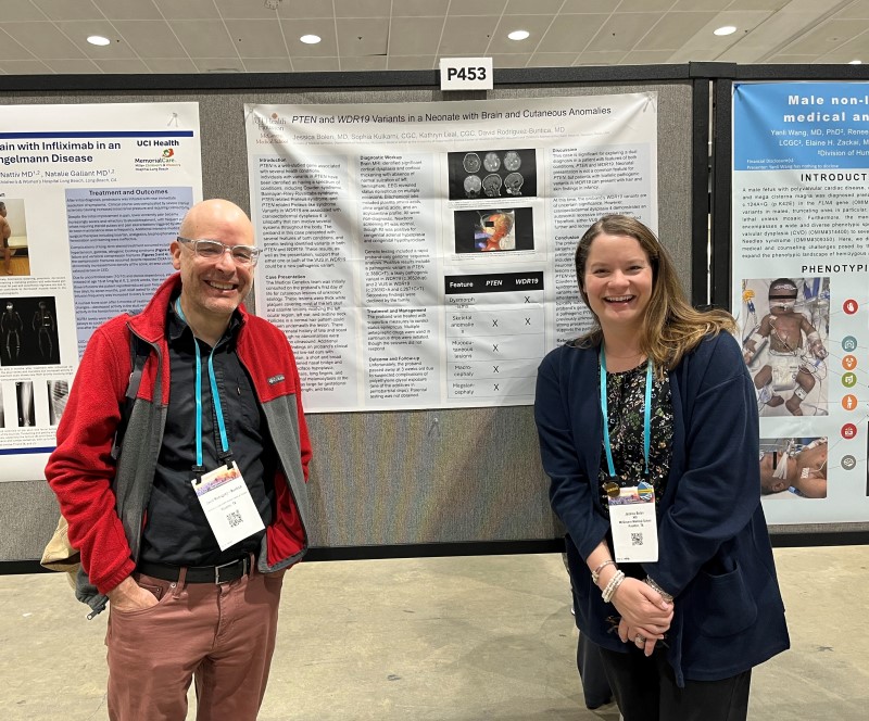 Two people standing in front of research poster