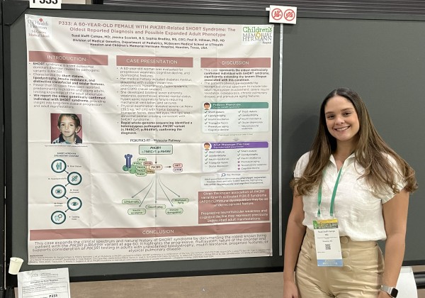 Suad in front of research poster