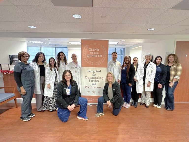 Group standing around banner