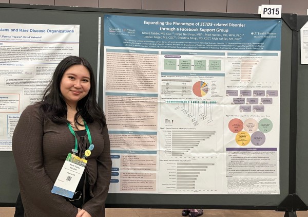 Nicole Talaba standing in front of poster