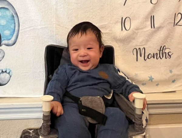 Smiling baby in high chair