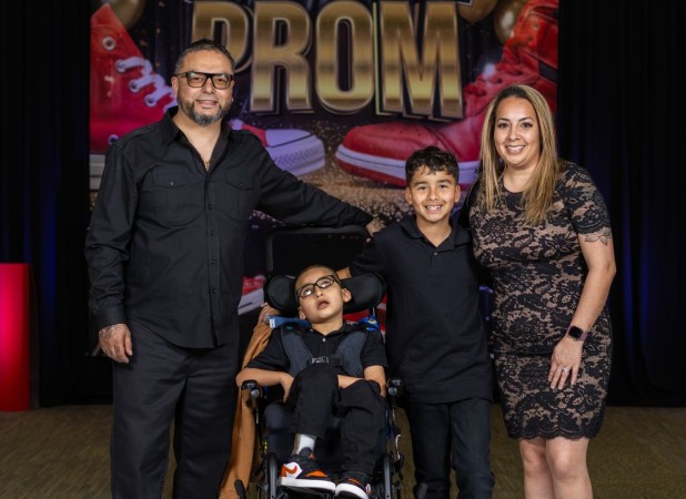 Family posing in front of Sneaker Ball backdrop
