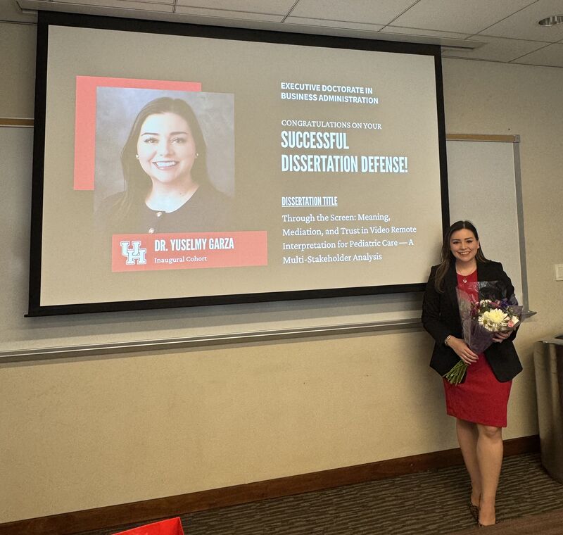 Woman standing in front of screen with PowerPoint slide