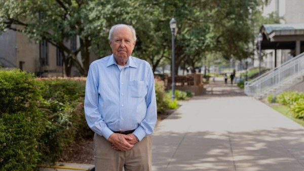 Older man in tree-lined courtyard