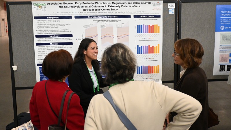 Allyssa Miller presents research poster to group
